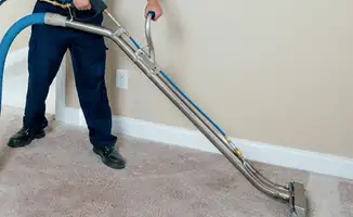 Professional operating a liquid removal machine on a carpeted floor in Las Vegas, NV